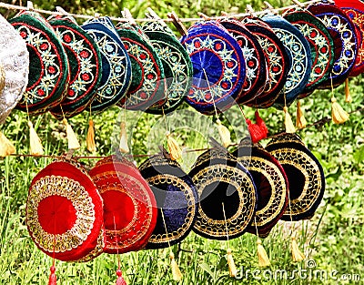 Colorful skull caps are on green grass background. Traditional muslim hat for crimeaâ€™s tatar and souvenirs for tourist. Stock Photo